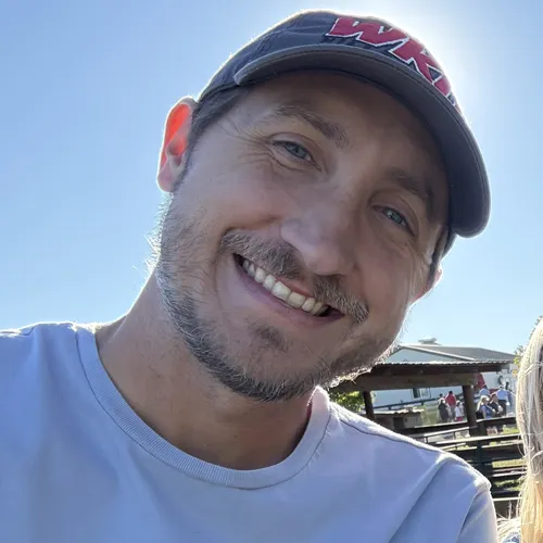 A profile picture of myself wearing a WKU hat on a bright sunny day at an orchard